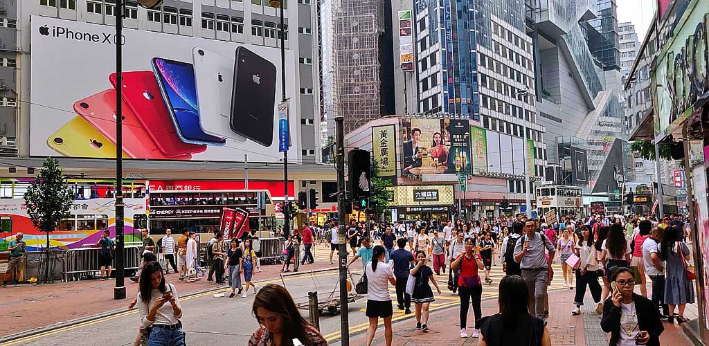 Causeway Bay Hong Kong shopping district - vibrant street scene with shoppers, neon signs, and modern buildings